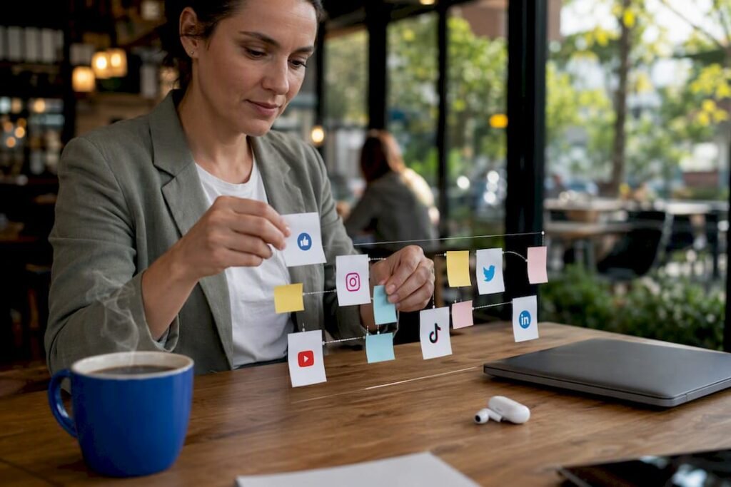 Hands organizing social media strategy notes over desk